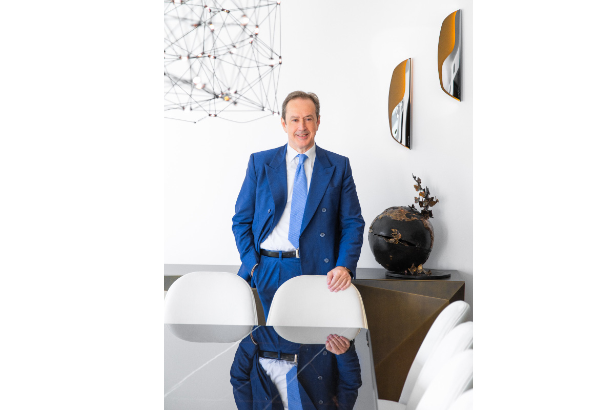 NewPrinces-Princes Group-Angelo Mastrolia, Newlat Food CEO. Man in blue suit stands in modern office. Food industry leader.-NewPrinces