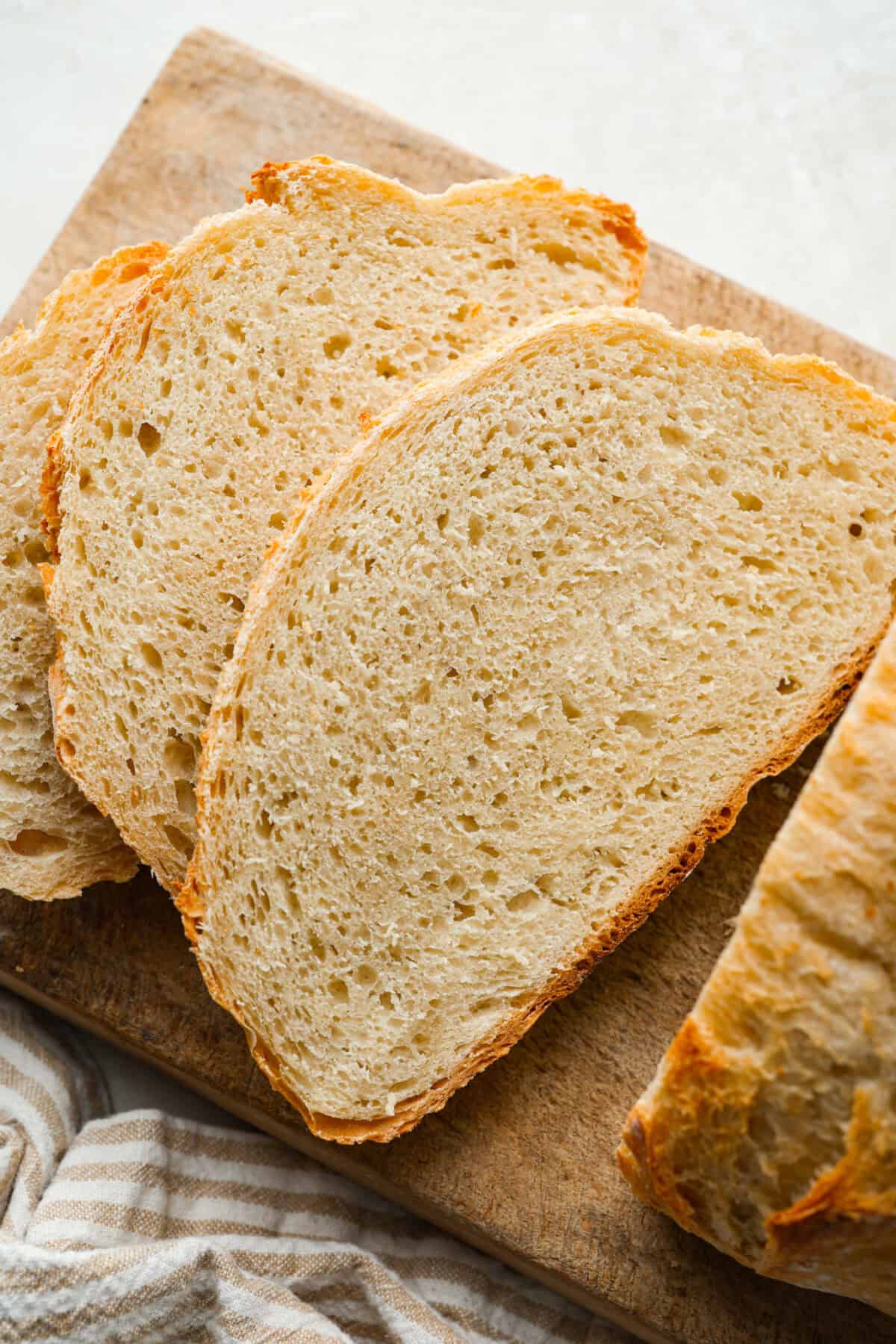 Artisan bread sliced on a cutting board.