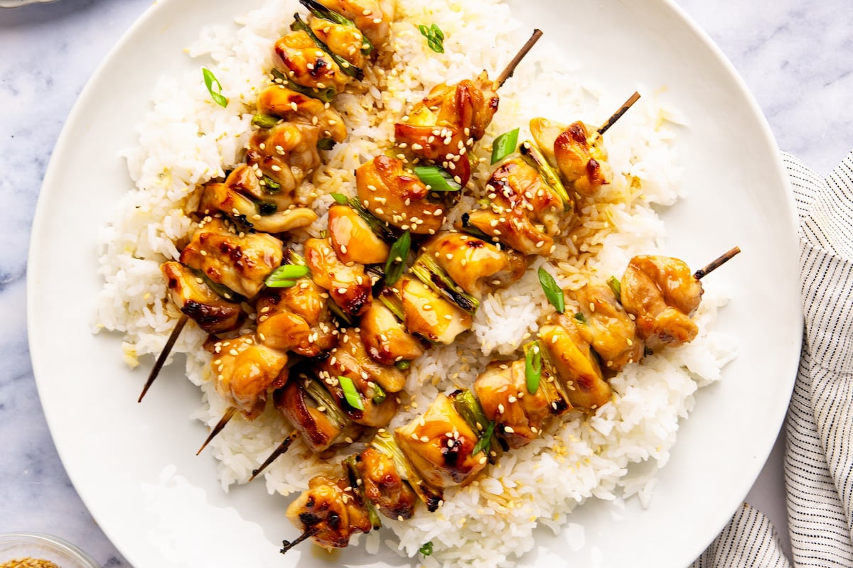 yakitori over rice on white plate