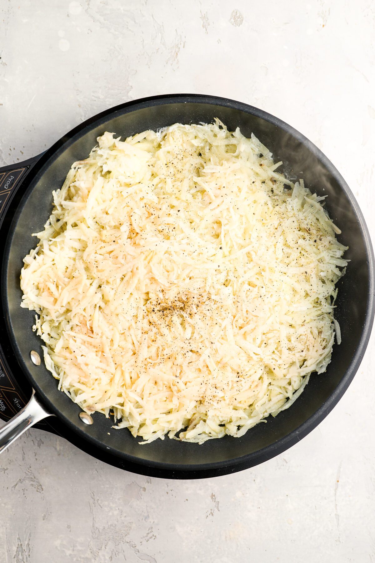 uncooked onion/potato mixture in cast iron skillet