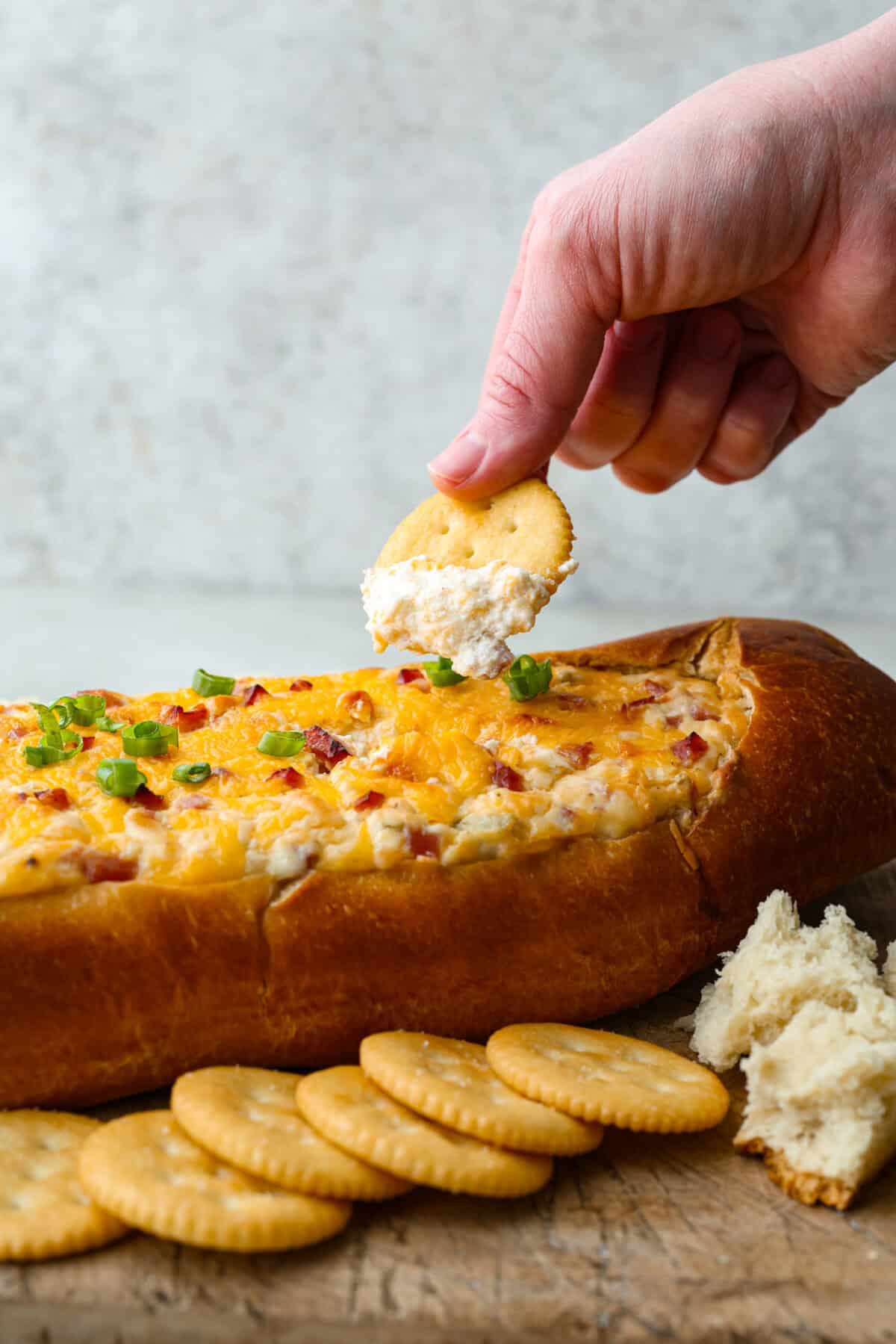 Someone scooping a bite of Mississippi sin dip from the loaf.