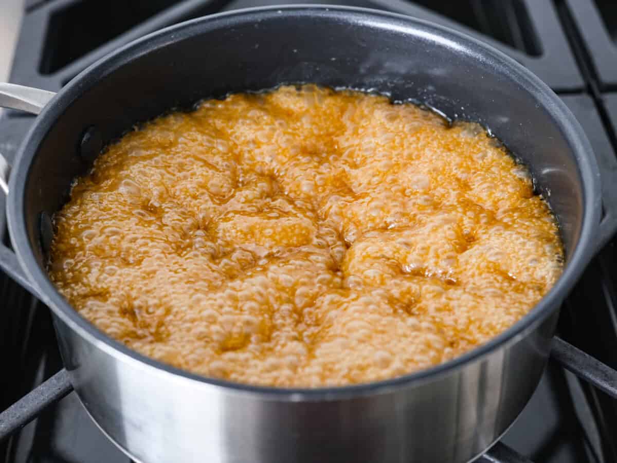 Toffee ingredients mixed together cooking in a pot.