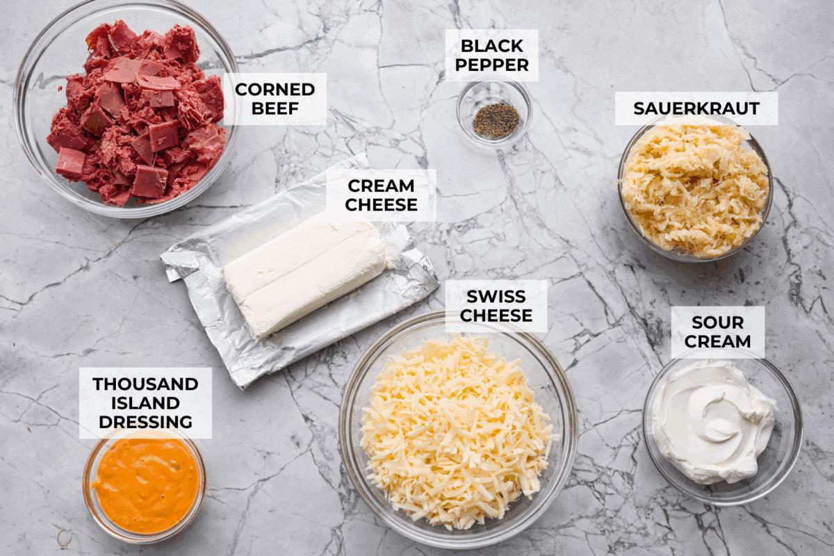 Overhead shot of labeled hot reuben dip ingredients. 