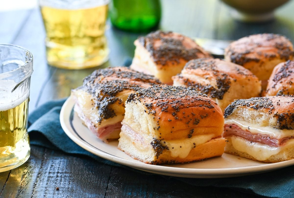 Ham and cheese sliders on a plate.