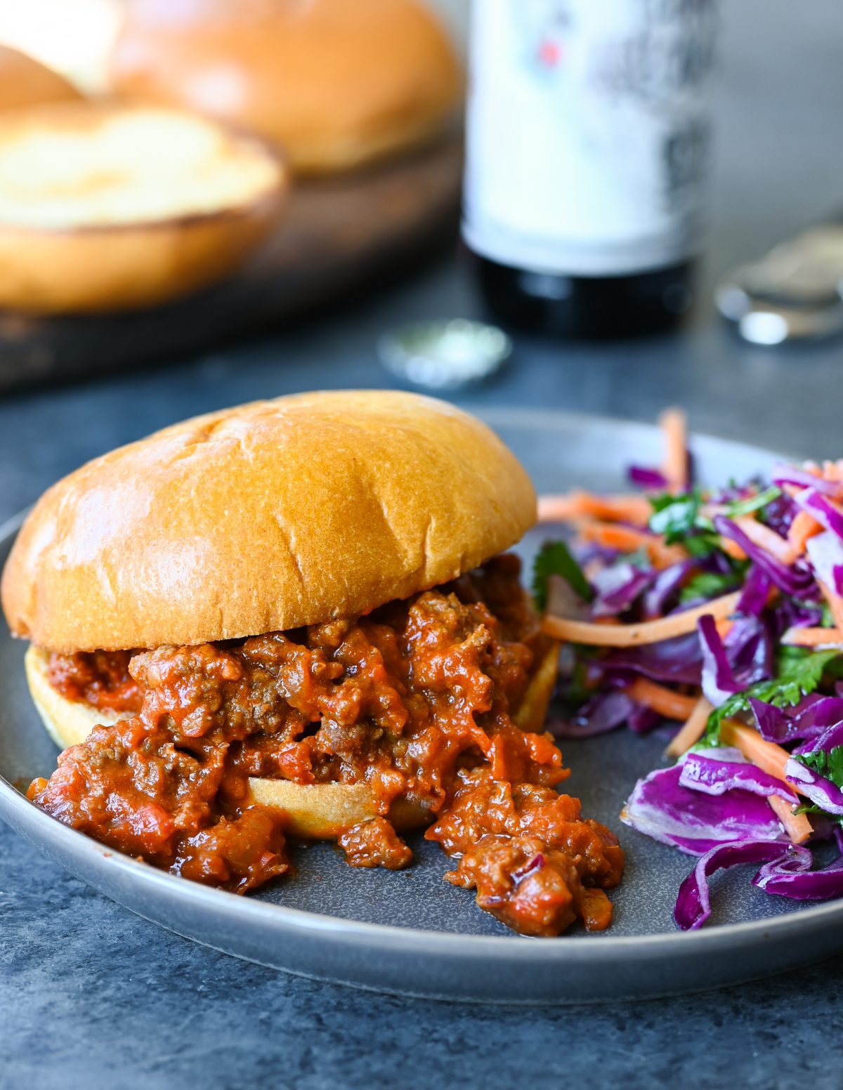 Sloppy joe on a plate with salad.