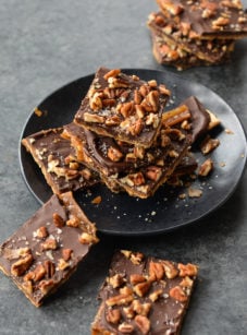 Matzo Crack on and around a black plate.