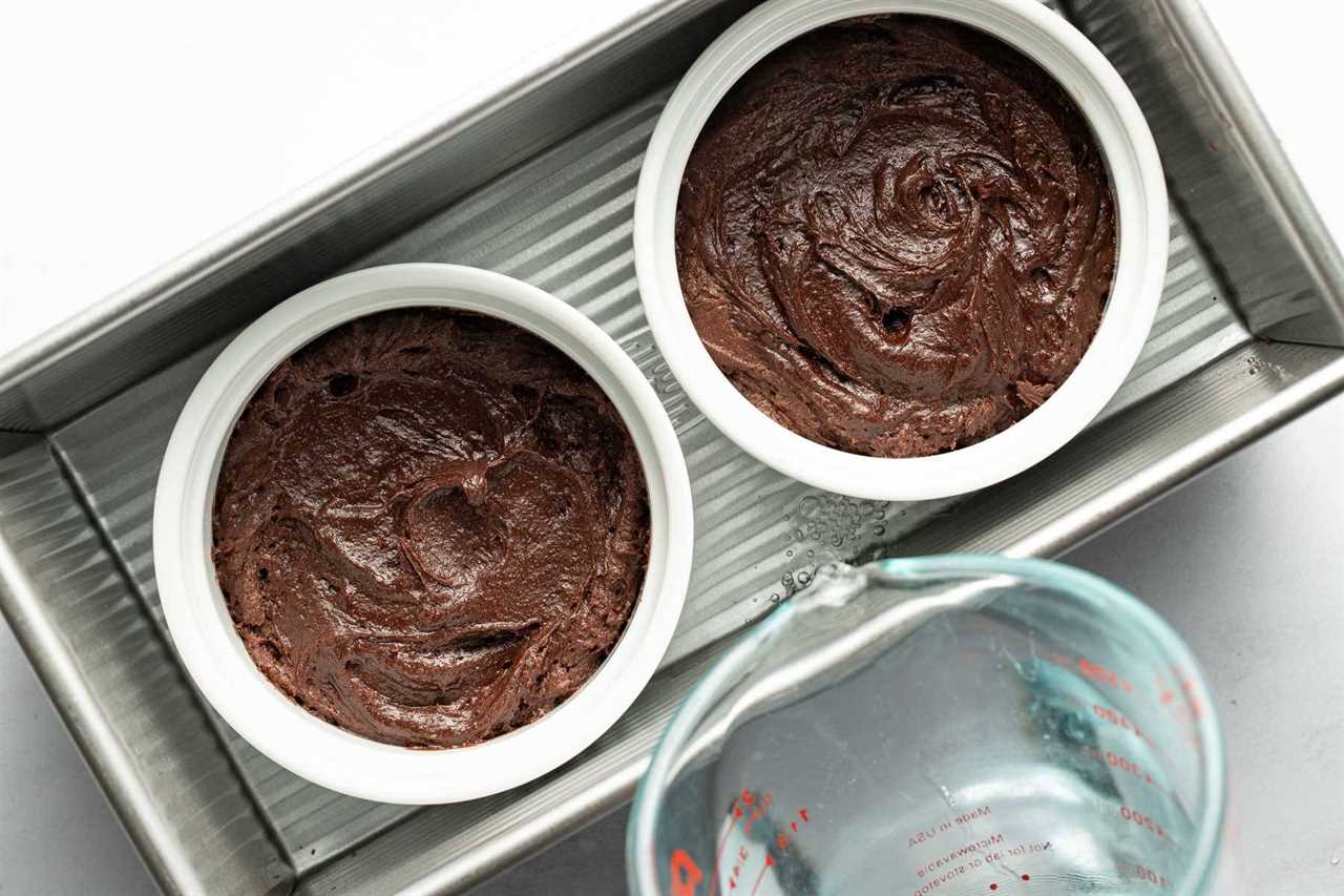 Adding brownie pudding batter to two ramekins.