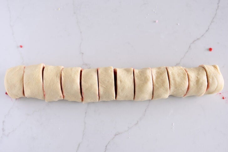 Raspberry sweet roll log cut into 12 pieces.
