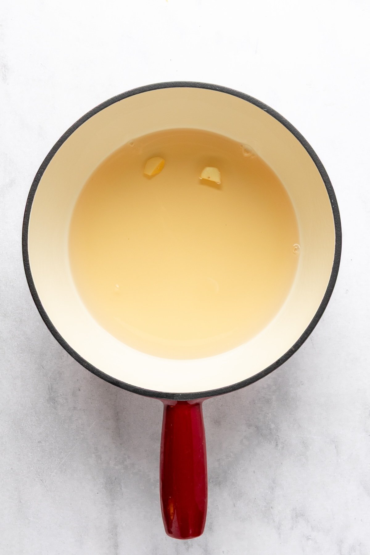 fondue pot with wine, kirsch, and garlic