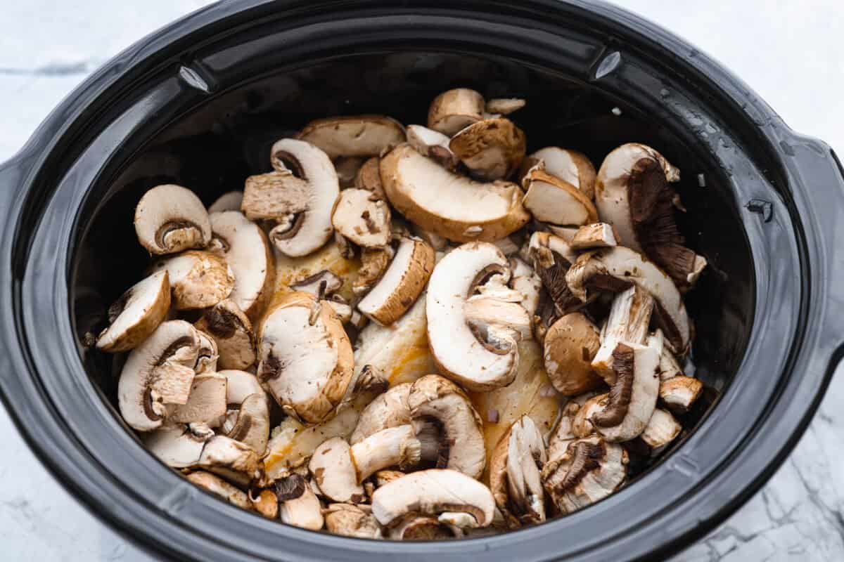 Chicken and mushrooms added to the crockpot. 