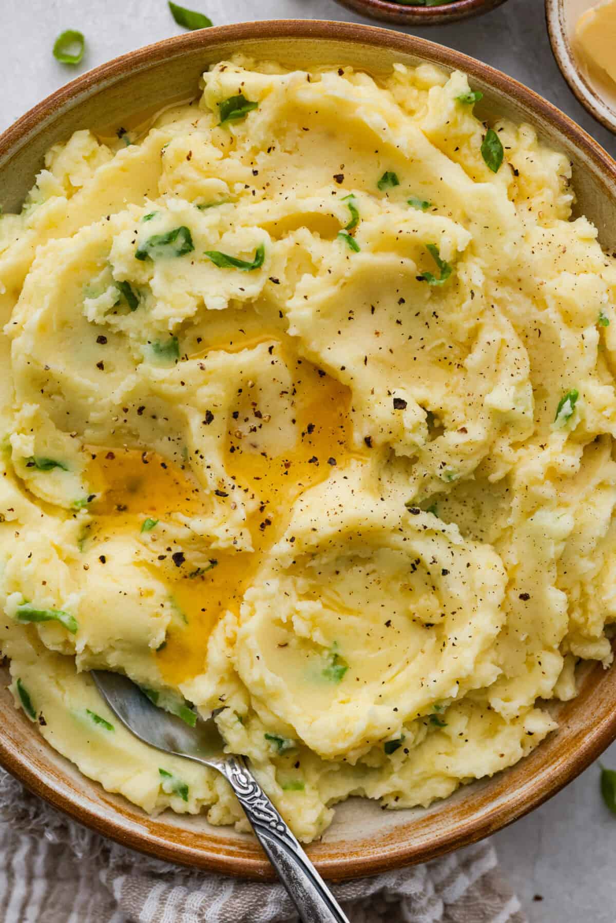 Bowl of Irish champ potatoes, with melted butter and slat and pepper. 