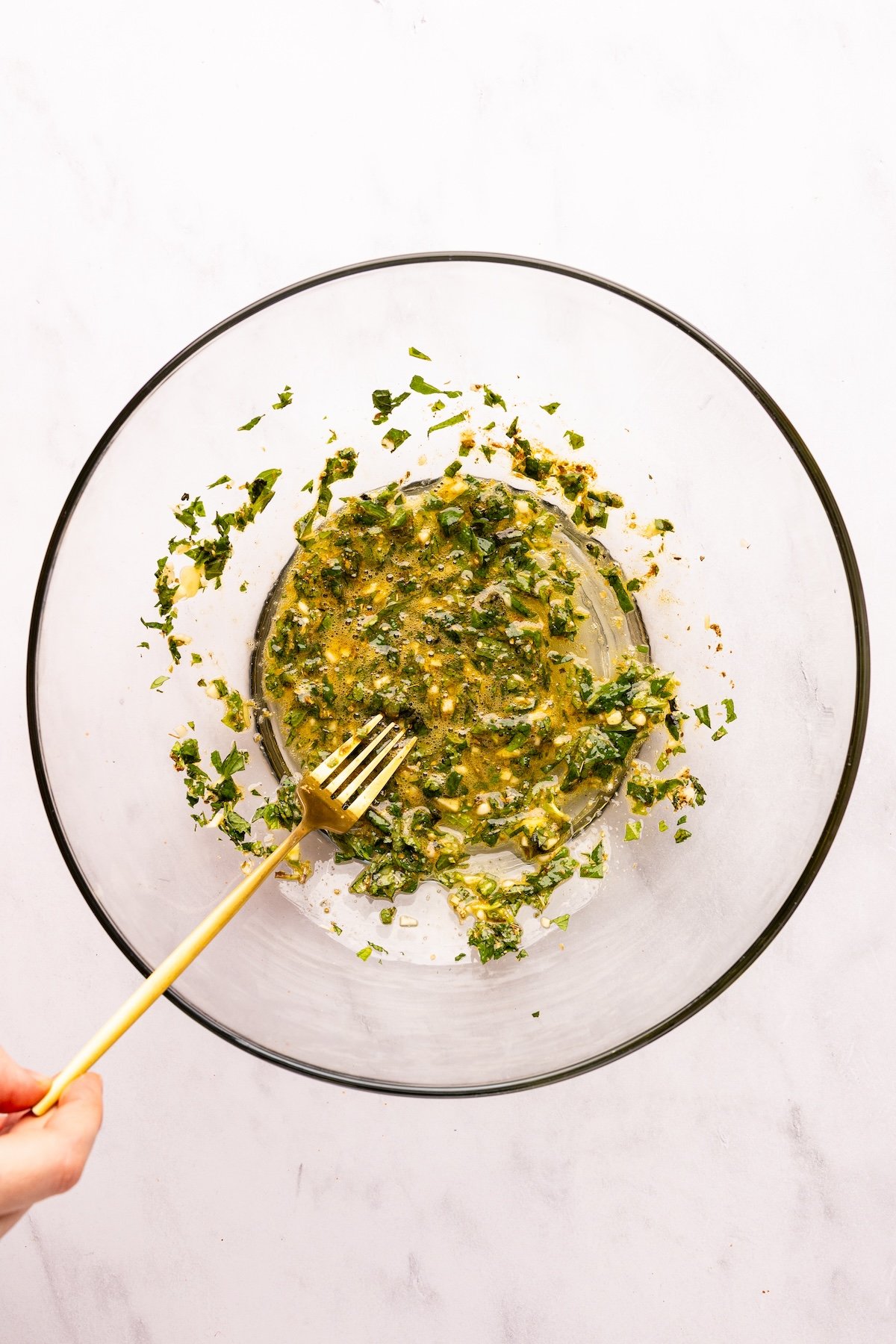 large bowl with egg, mint, garlic, oregano, cumin, and salt mixed together