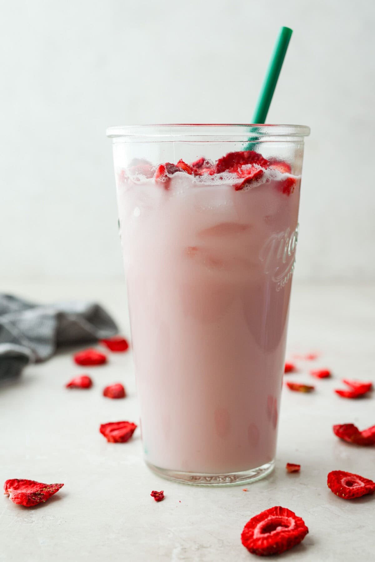 Large glass with Starbucks copycat pink drink and green straw. 