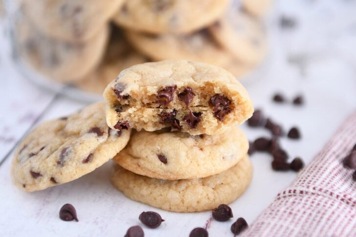 Mini chocolate chip cookie split in half stacked on two cookies.