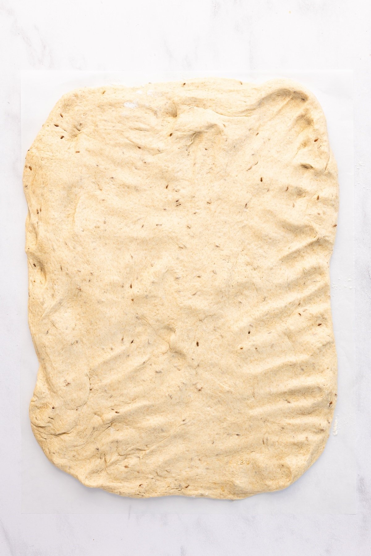 rye bread dough flattened into an 8 x 10-inch rectangle