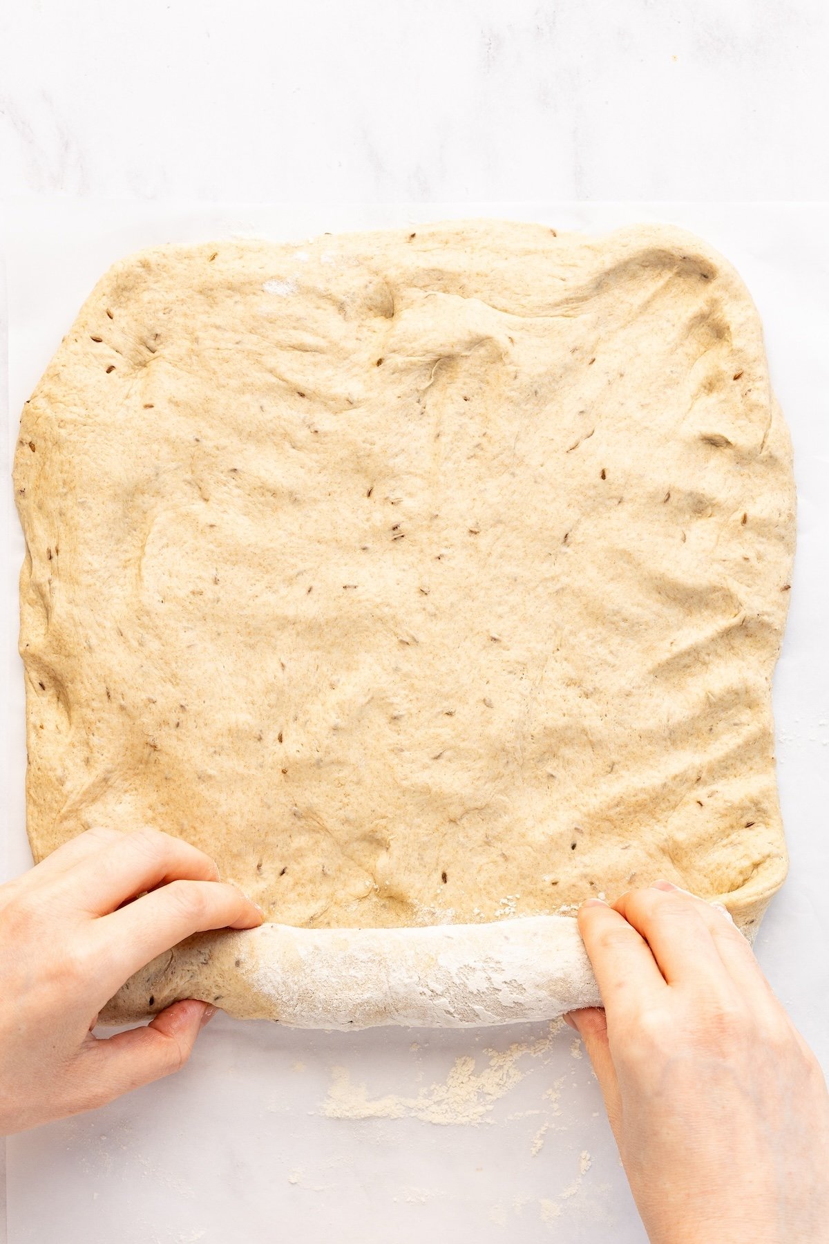 rolling up dough rectangle into a loaf shape