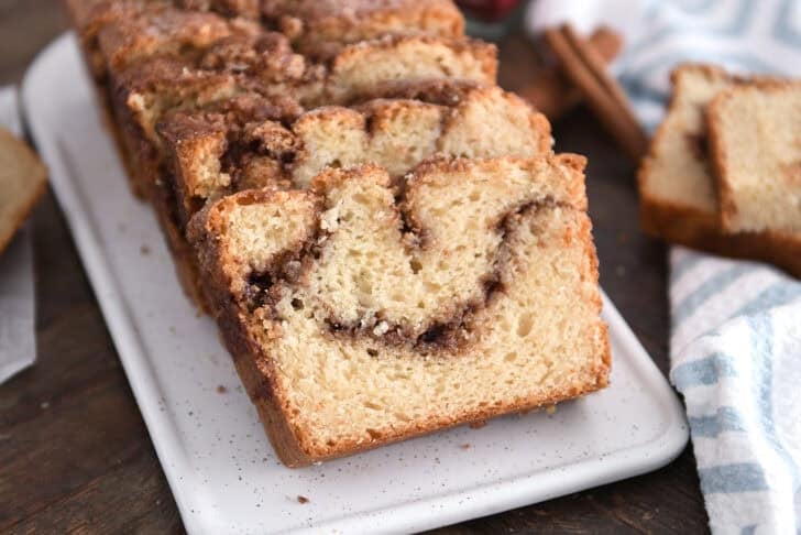Three slices of cinnamon swirl quick bread on white tray.