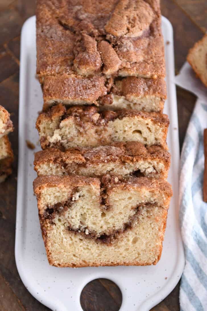 White tray with four slices of cinnamon swirl quick bread.