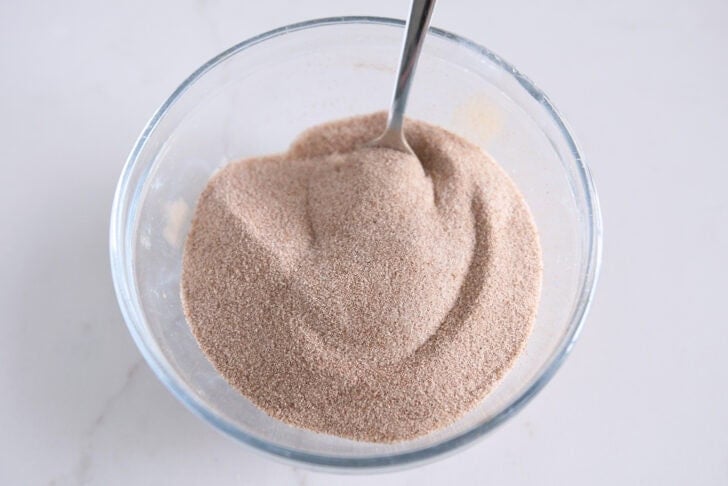 Small glass bowl with mixed cinnamon and sugar mixture.