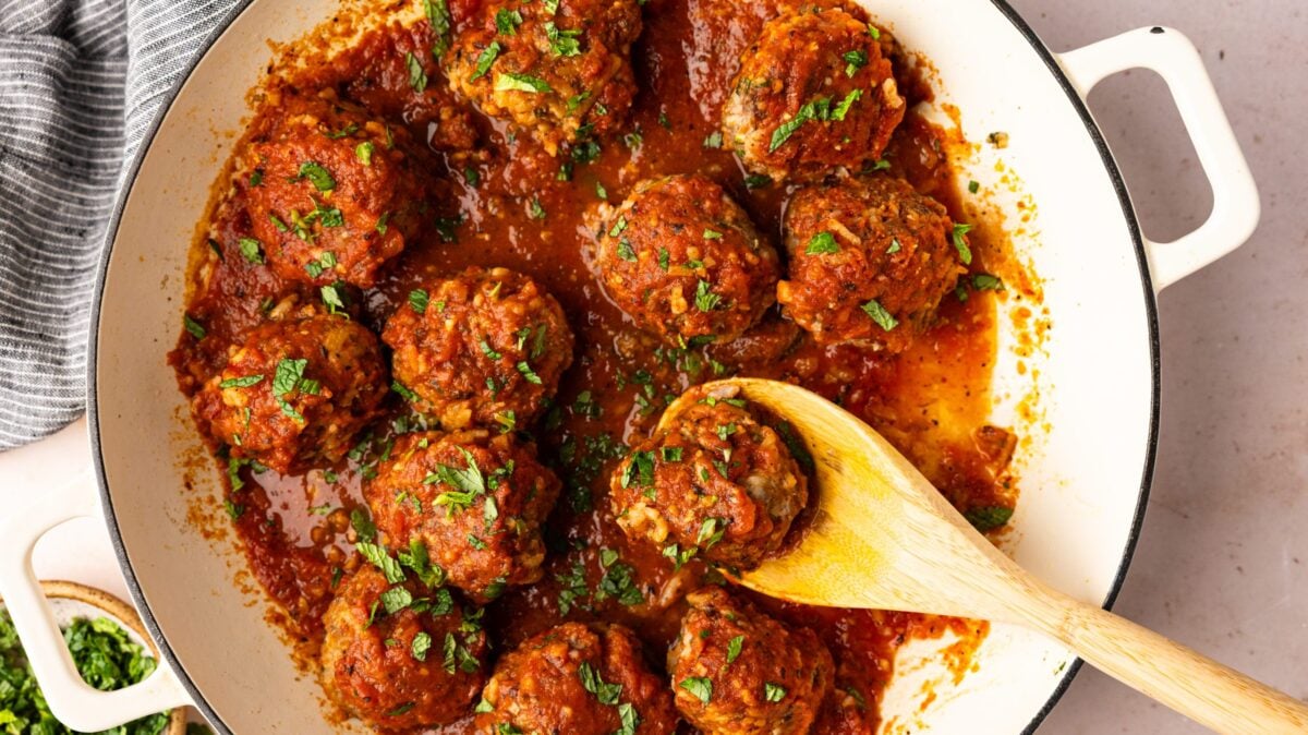 albondigas in pot with wooden spoon