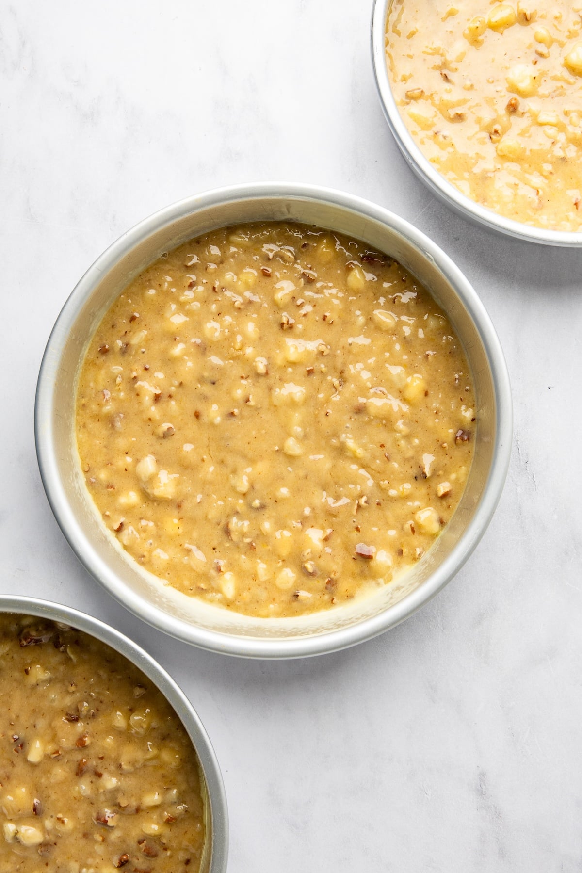 hummingbird cake batter divided between three 9-inch round cake pans