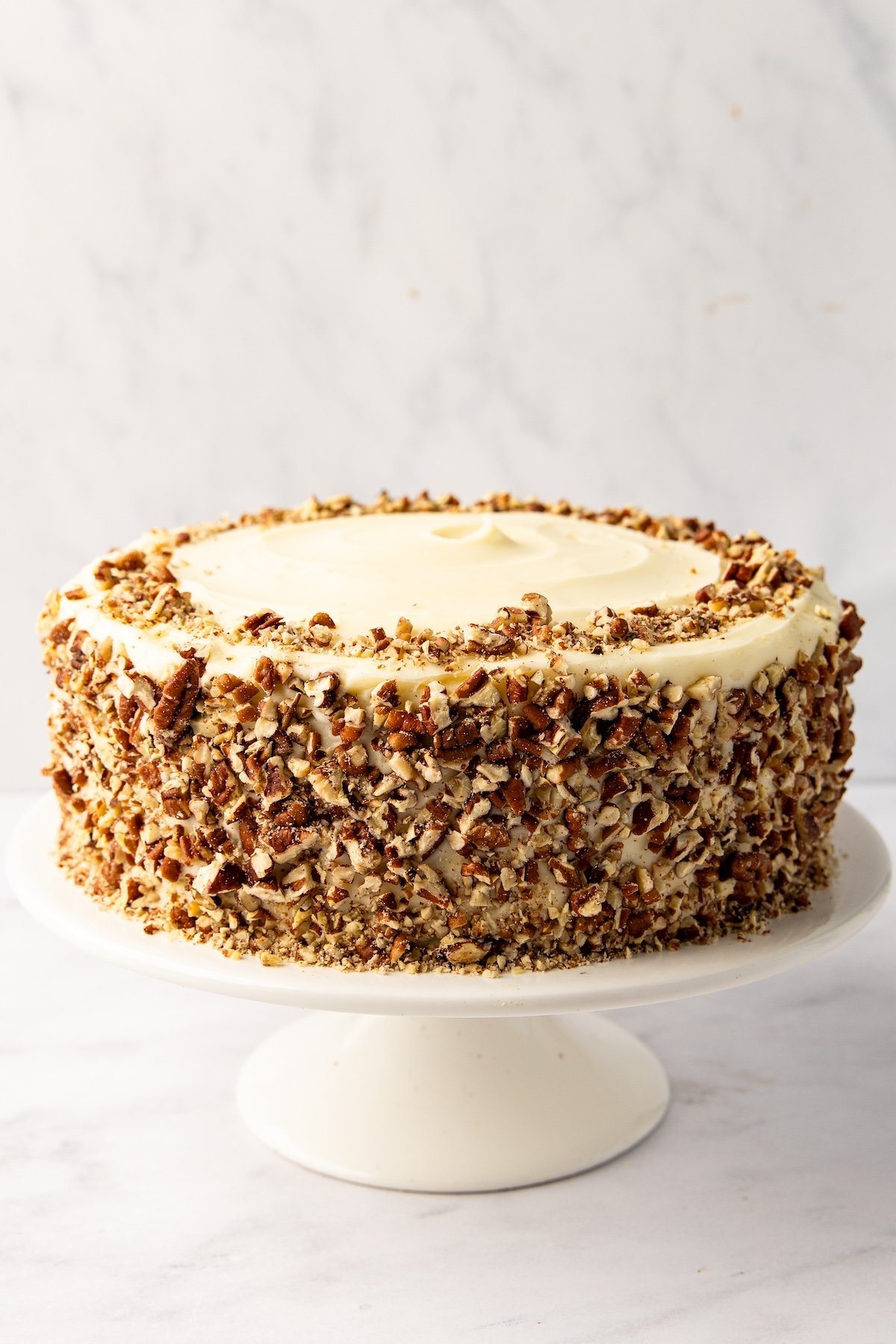 cake with chopped pecans covering side and outer edge of top