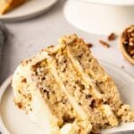 Slice of hummingbird cake on a white plate.