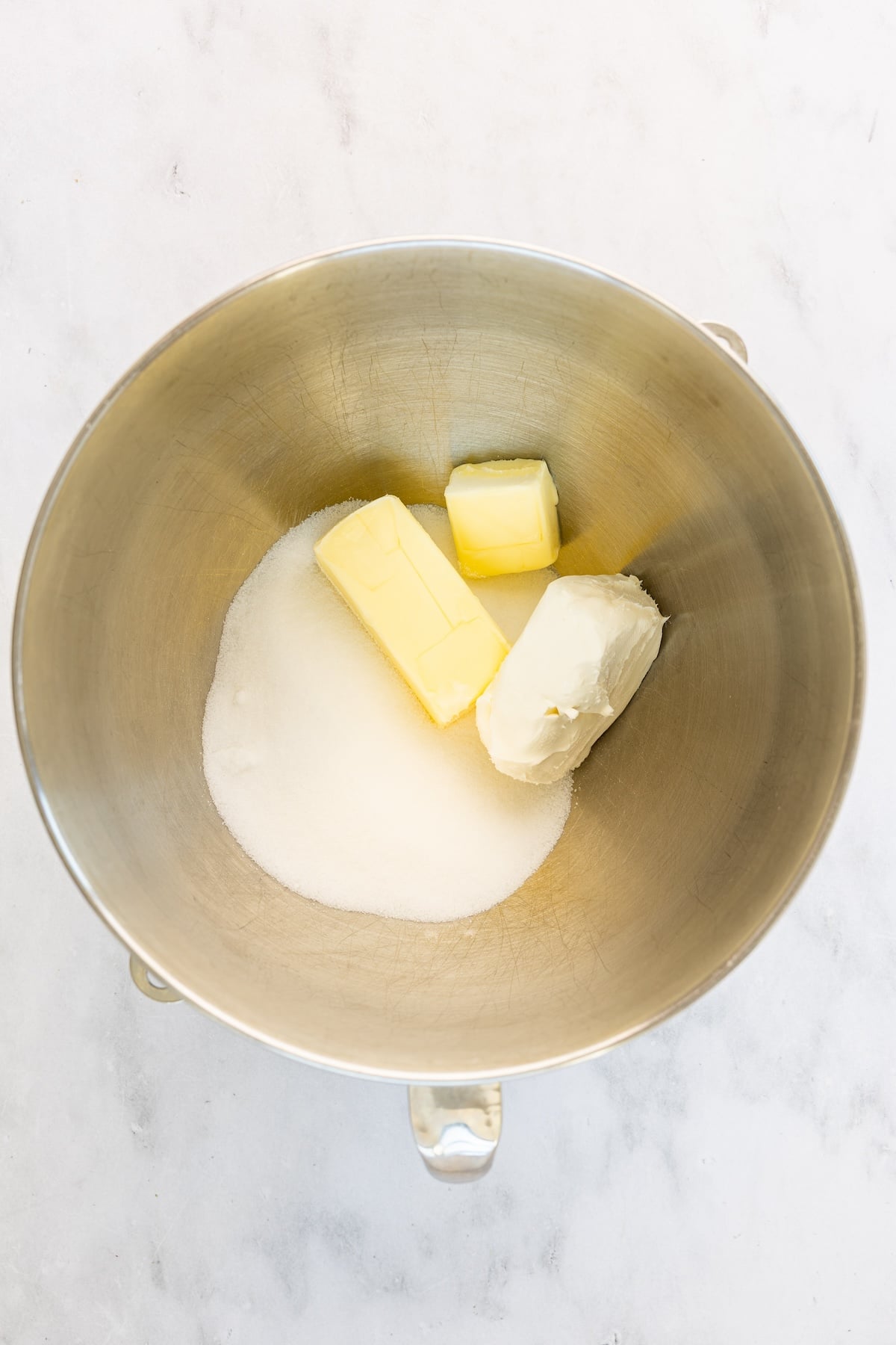 mixing bowl with butter, cream cheese, and sugar