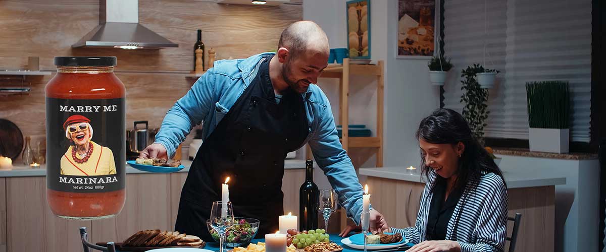 Marry Me Marinara gourmet pasta sauce for a romantic Italian dinner for two — candlelit table with wine and fresh pasta