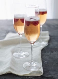 Tall stemmed glasses of kir royale.