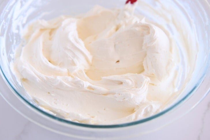 Glass bowl with whipped cream cheese frosting.