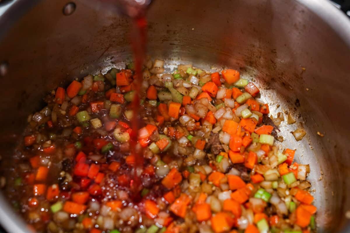 Wine being added to the veggies. 