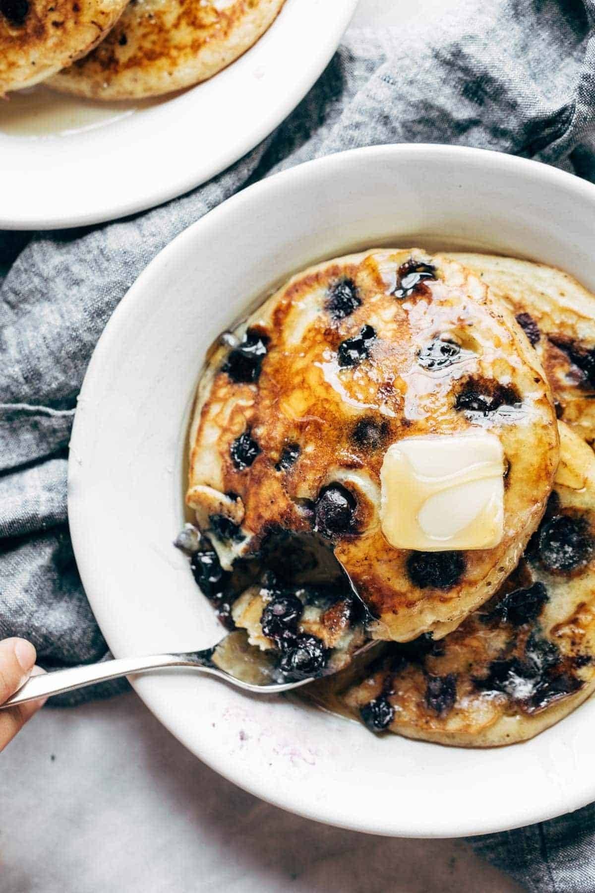 Blueberry pancakes with butter and syrup.