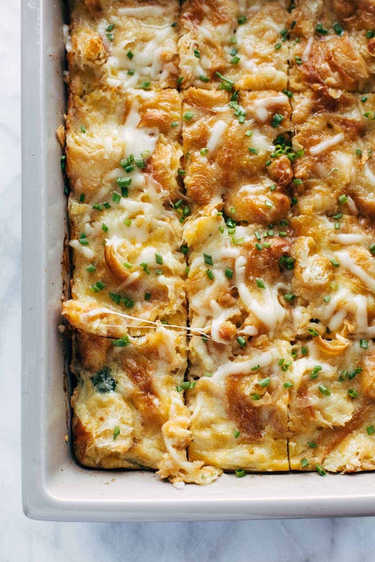 Egg and croissant bake in a pan.