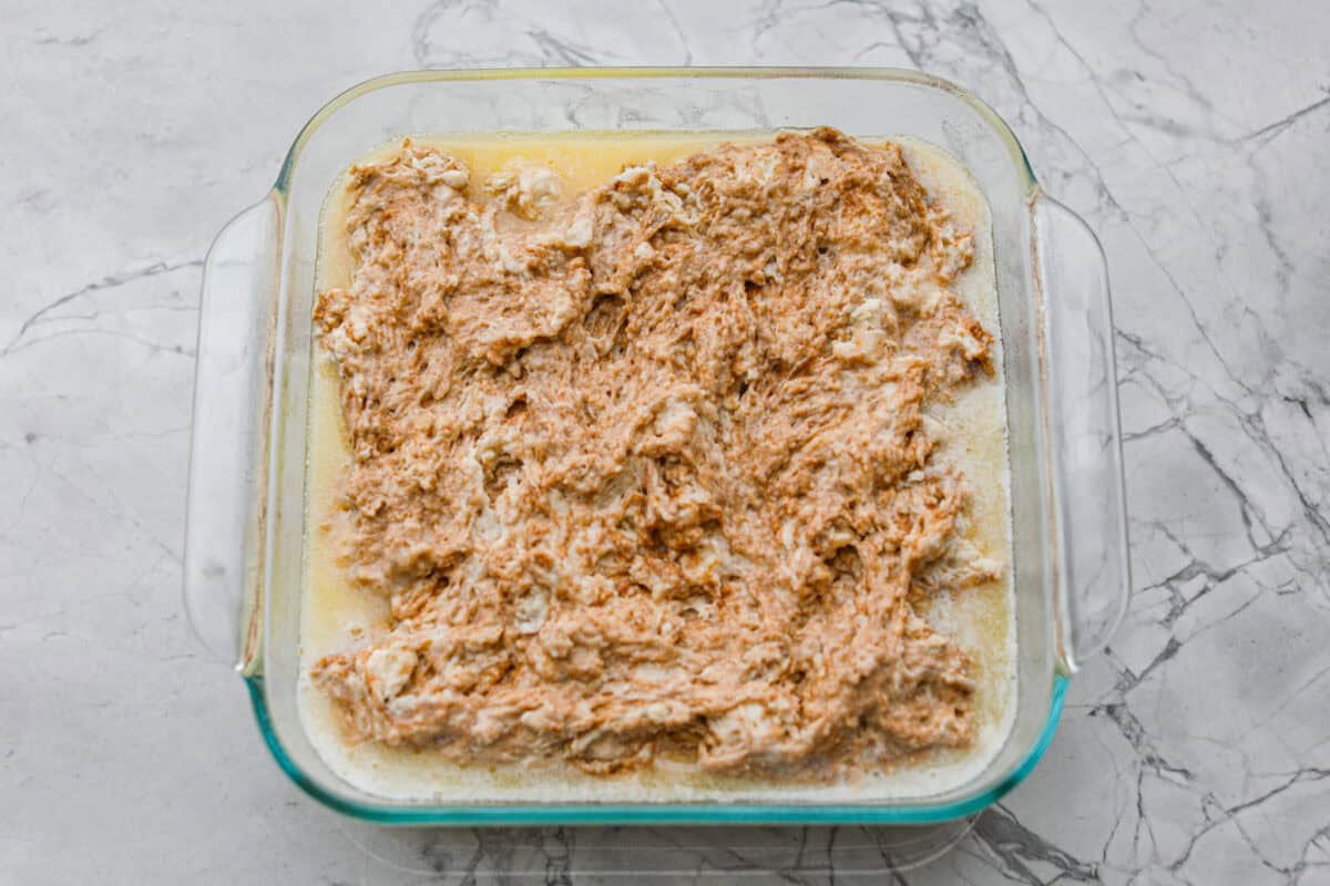 Melted butter added to the baking dish and biscuit mixture on top. 