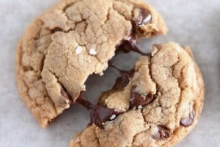 Top down view of chocolate chip cookie pulled in half with melty chocolate chips.