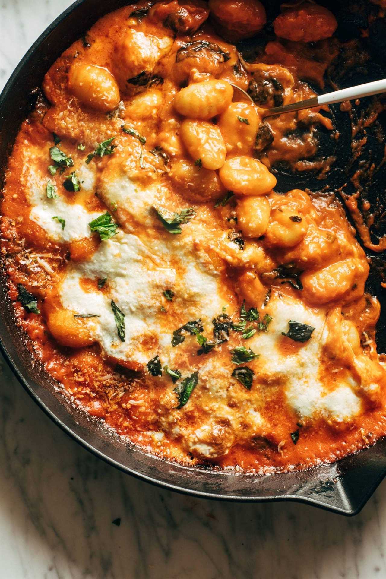 Baked gnocchi in a cast iron skillet.
