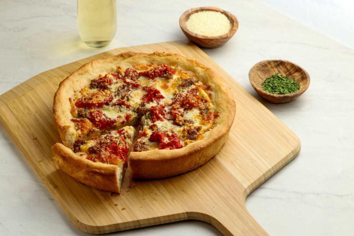 deep dish pizza on cutting board