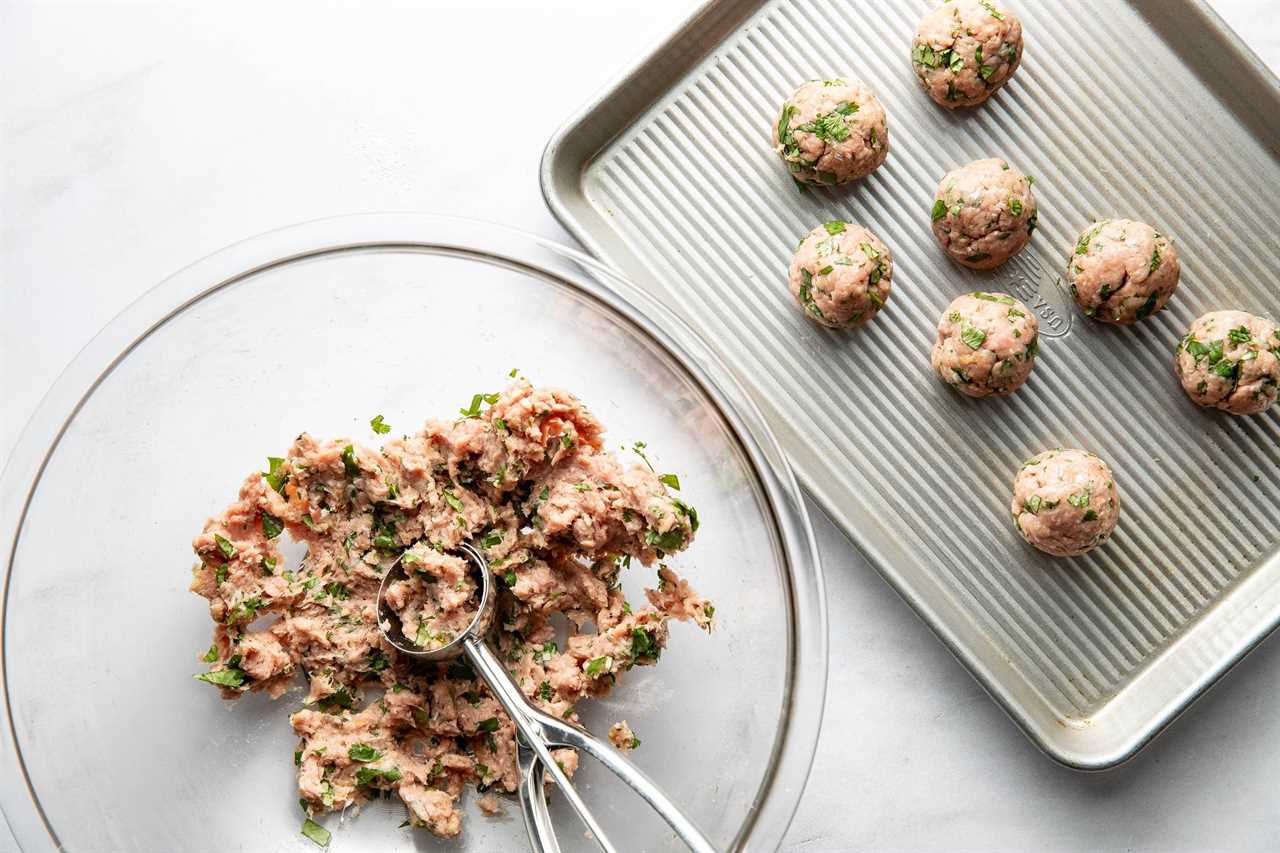 Forming meatballs into balls.