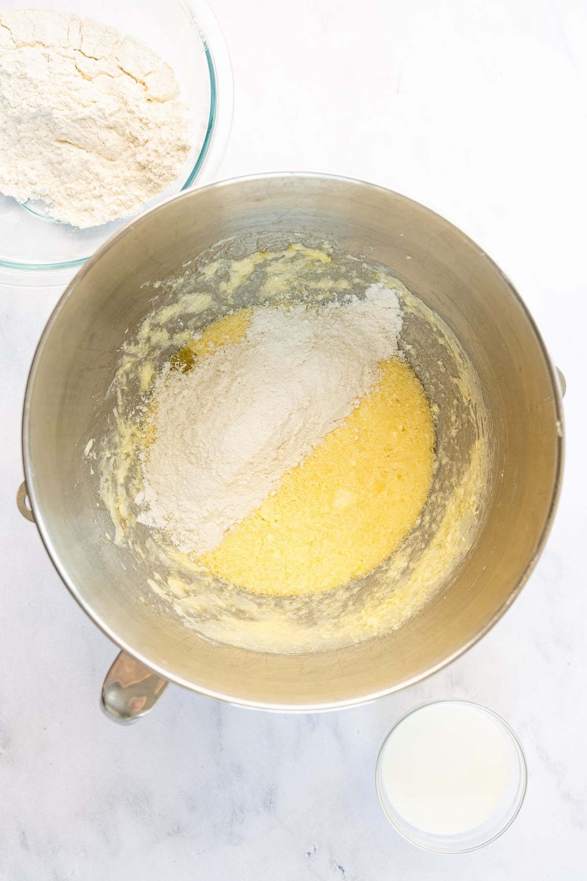 flour and milk added to mixing bowl with butter/sugar/egg mixture