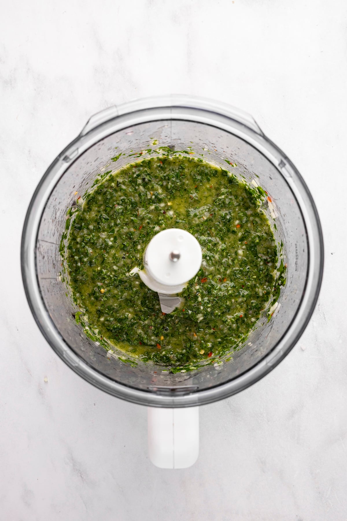 olive oil, vinegar, lemon juice, garlic, shallot, salt, pepper, red pepper flakes, parsley, cilantro, and mint pulsed into chimichurri sauce