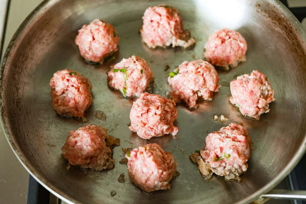 Meat balls in a hot skillet.