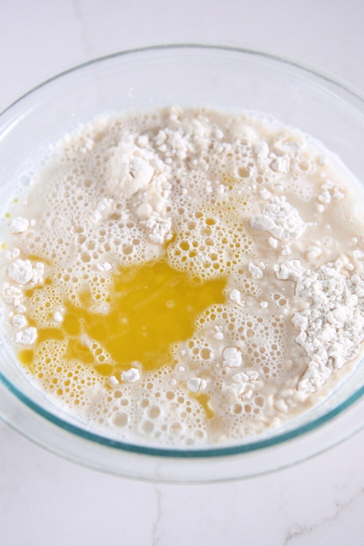 Glass bowl with water, olive oil, flour and water.