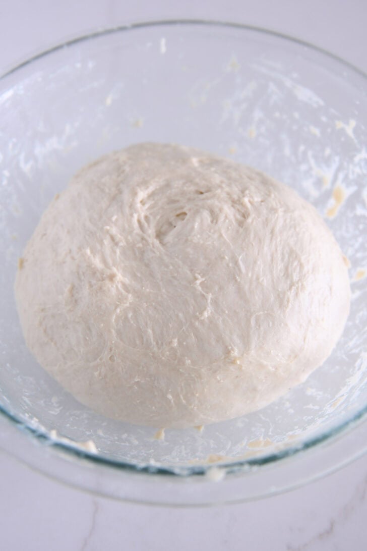 Focaccia dough in glass bowl.