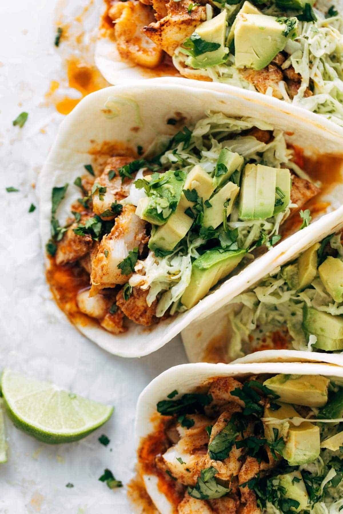 Fish tacos with slaw and avocado.