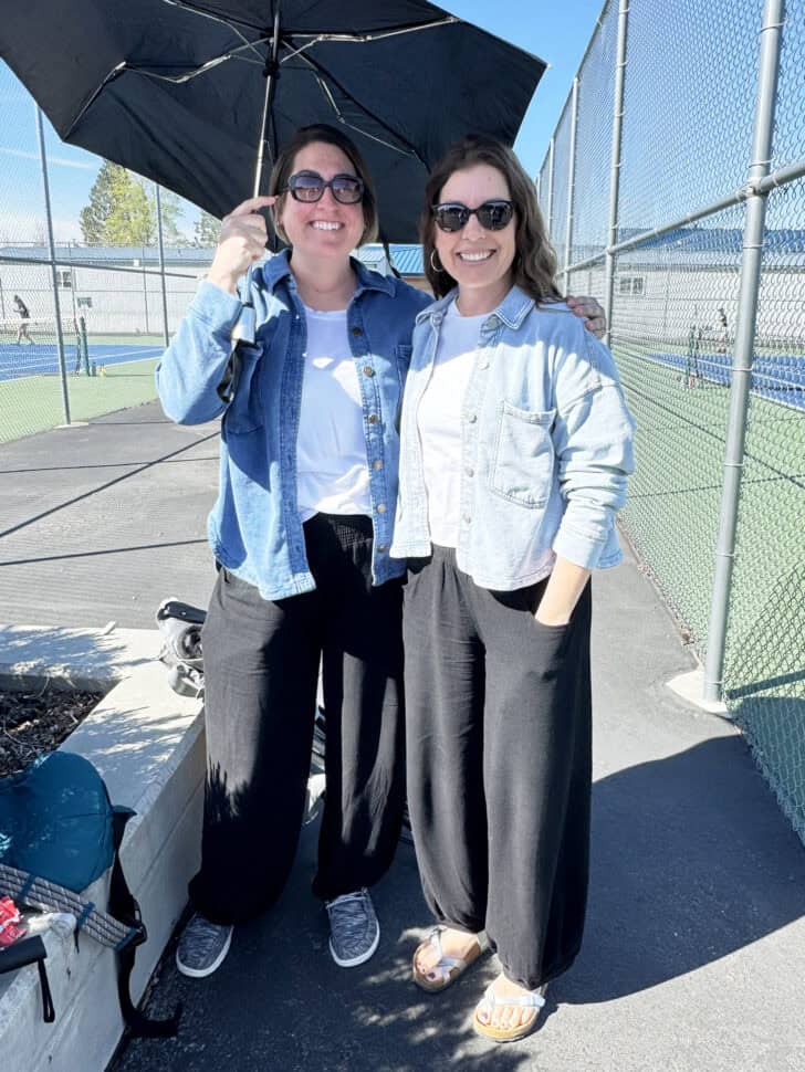 Mel and sister at tennis match in same outfit. 