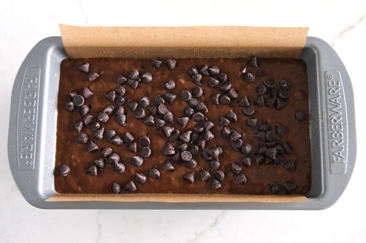 Top down view of unbaked loaf of chocolate banana bread.