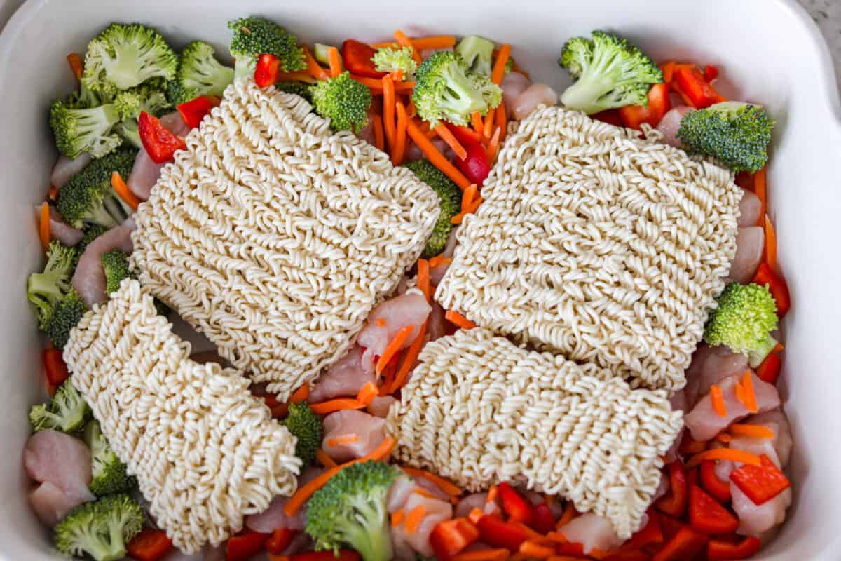Ramen noodles added to the baking dish with the chicken and veggies. 