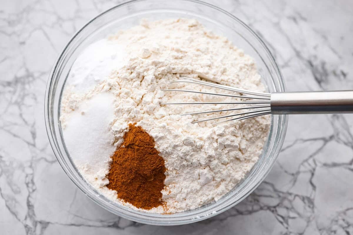 Dry ingredients added to a mixing bowl, ready to be whisked together. 
