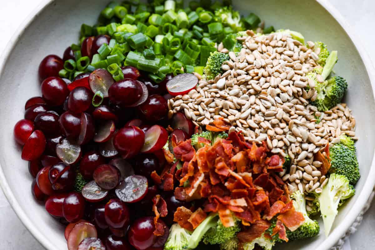 All of the salad ingredients added to a bowl. 